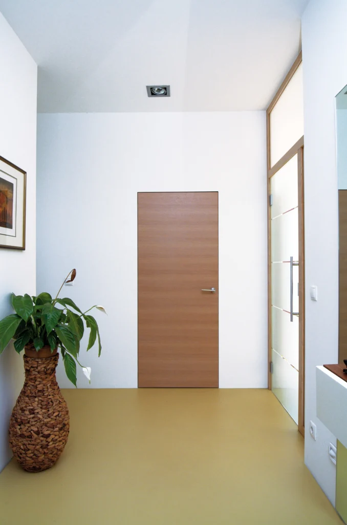 Moderne wandbündige Eiche-Innentür im hellen minimalistischen Flur